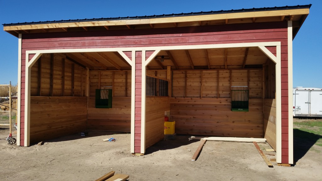 Installing trim on the horse shed 