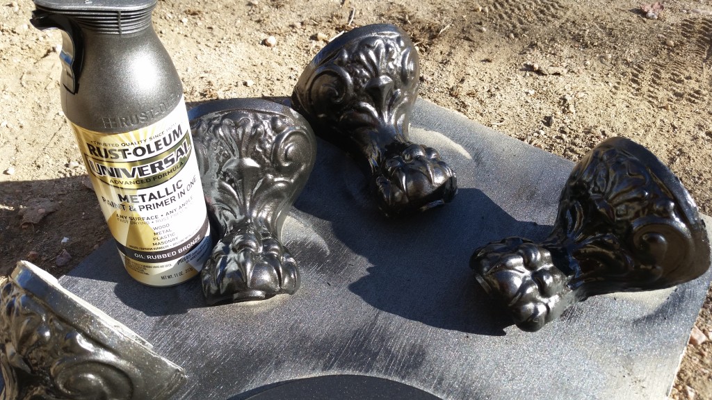 Painting the tub feet with Oil Rubbed Bronze spray paint.